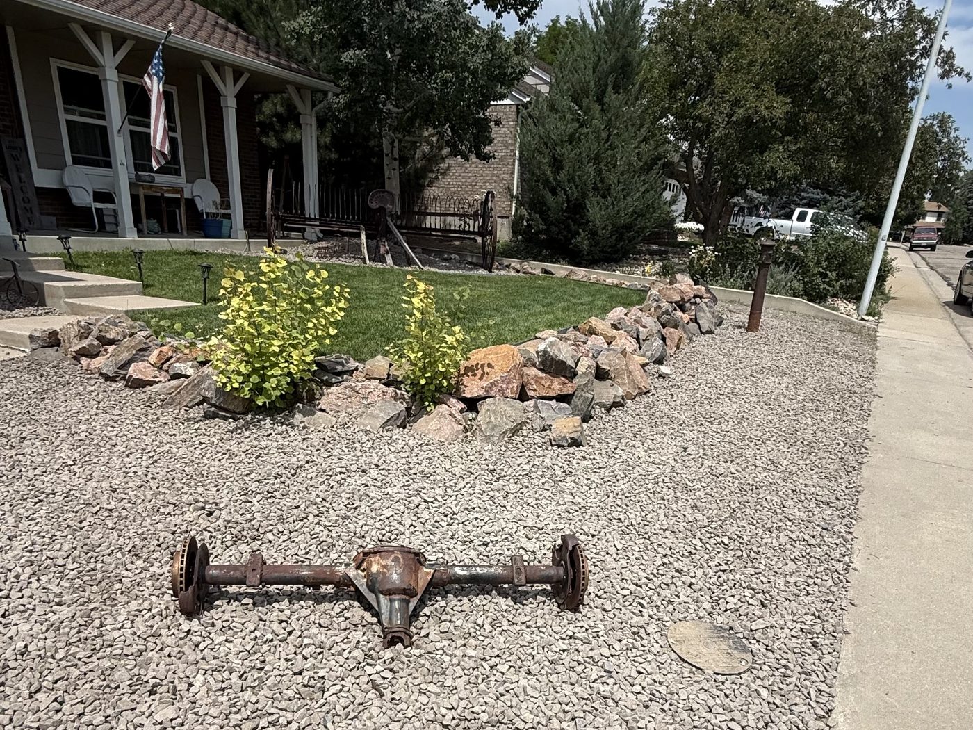 Front yard rock installation with decorative axle centerpiece